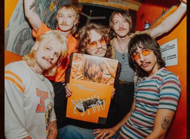 The Macks pose together with a vinyl copy of The Macks are a Knife